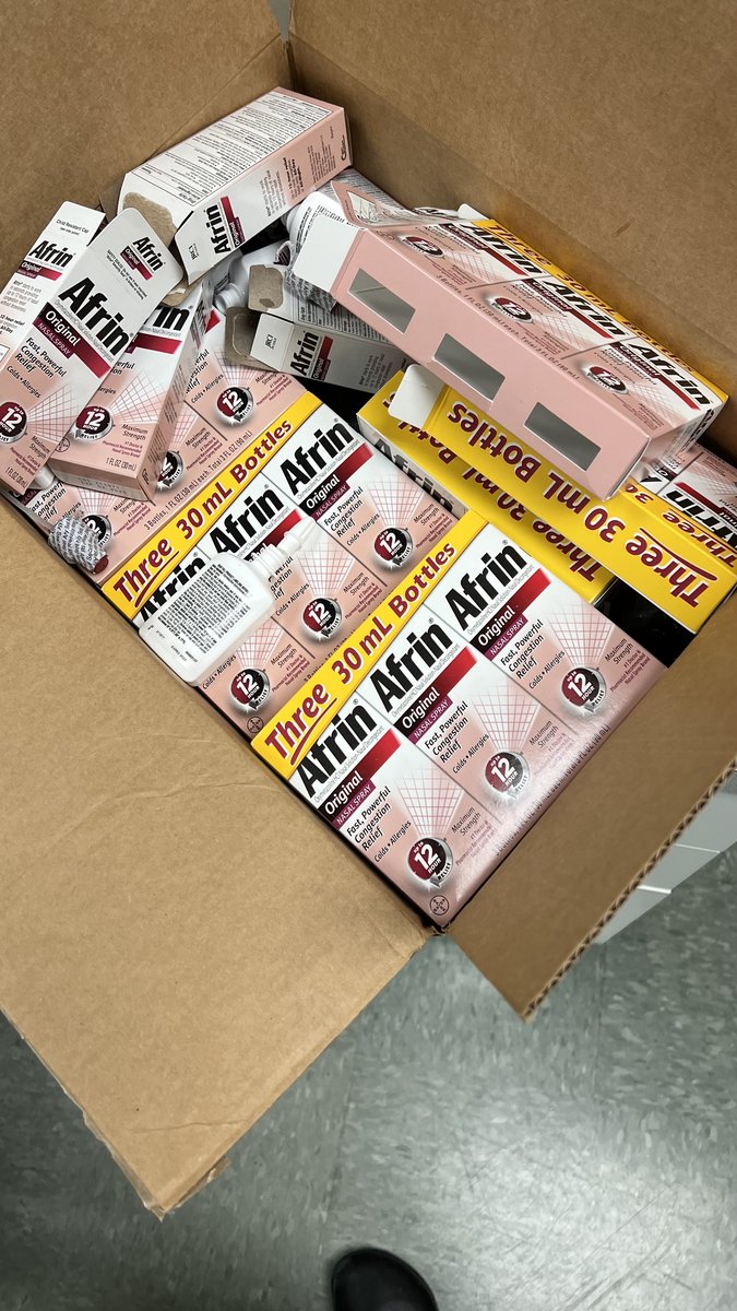 A cardboard shipping box filled to the brim with boxes of Afrin nasal spray.
